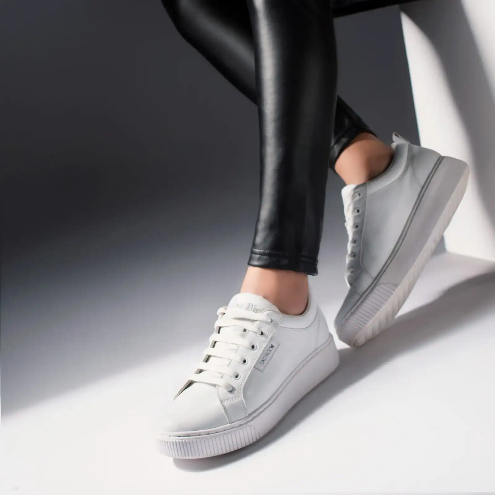 A pair of white leather sneakers