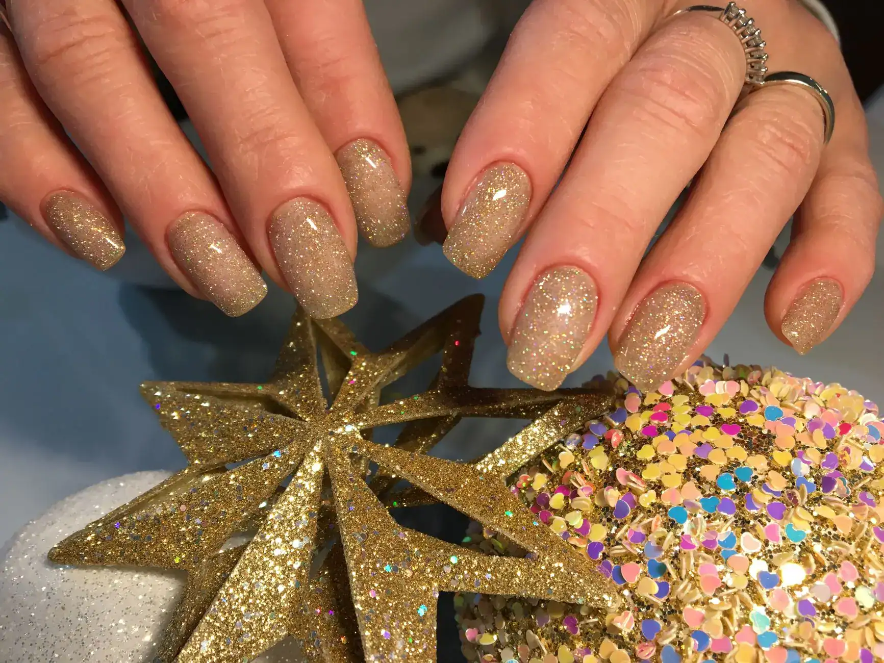 Gold glitter nails with tiny gold star details