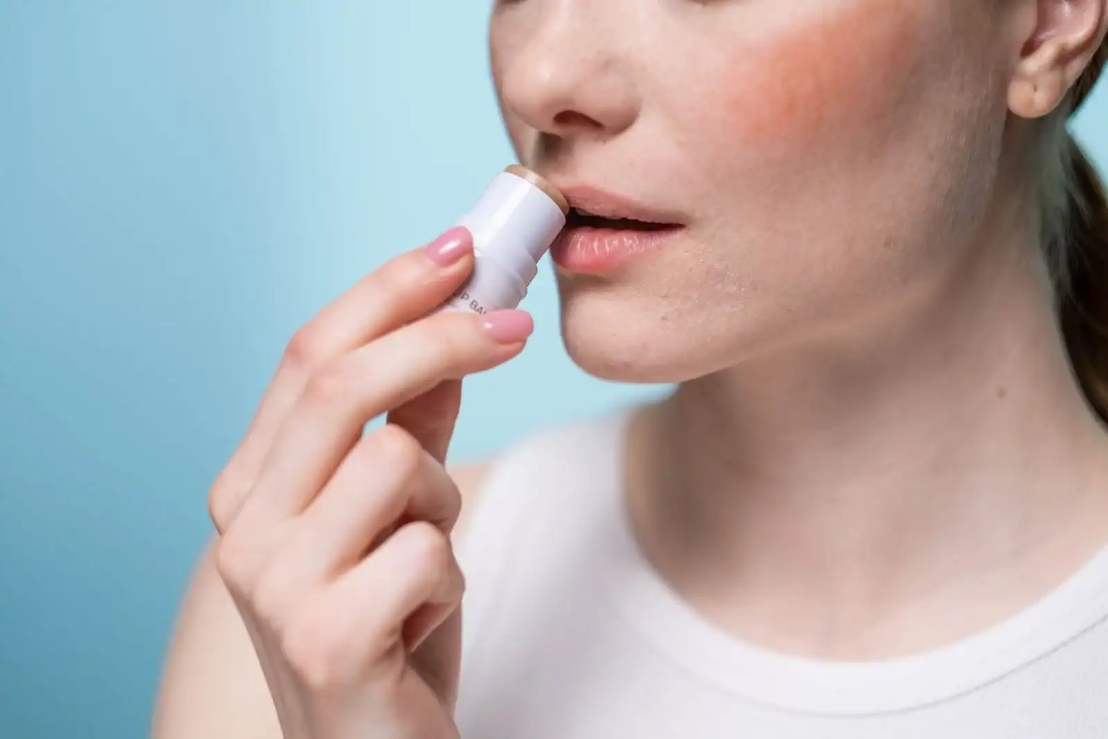 A close view of a person applying lip balm