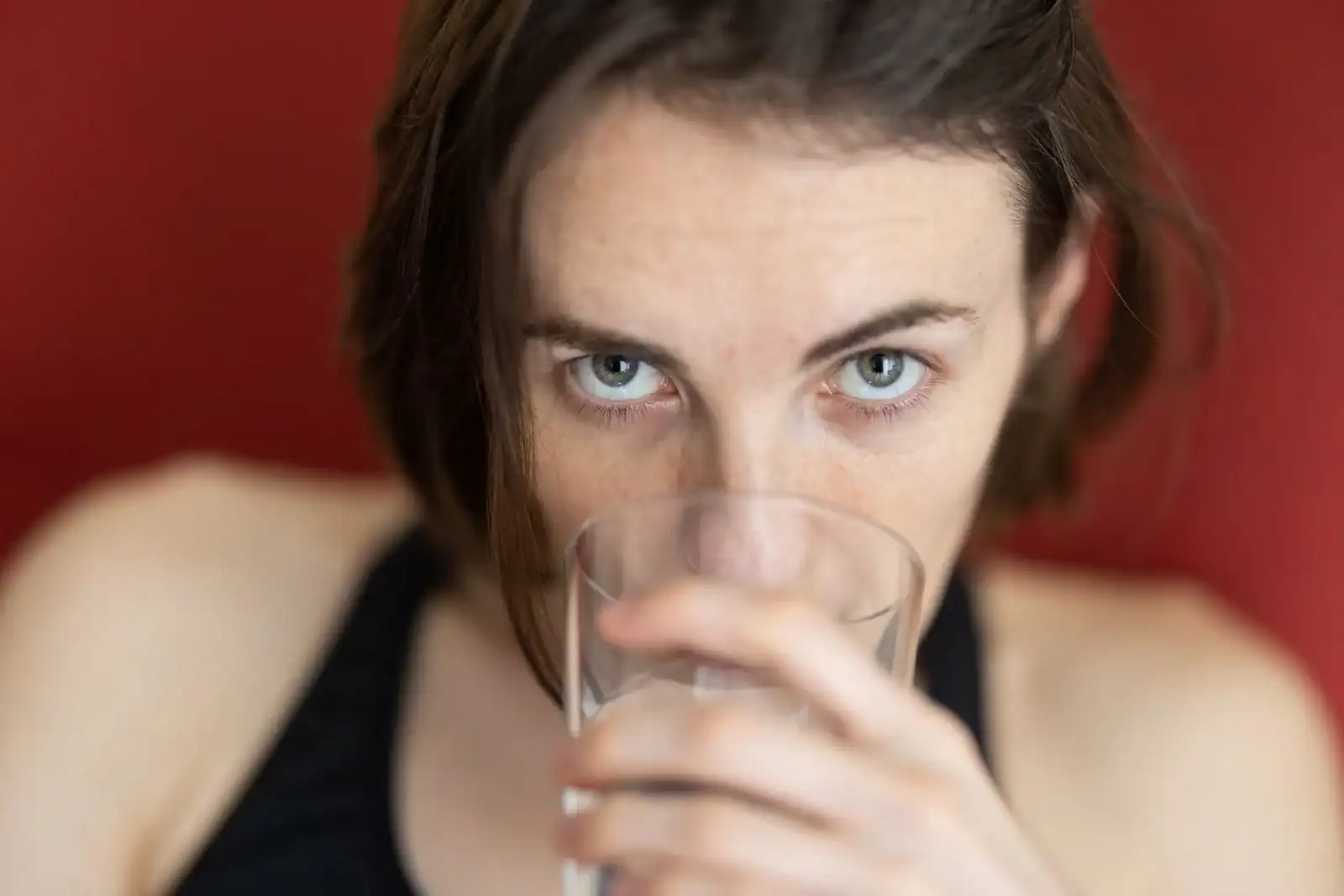 A woman drinking a glass of water