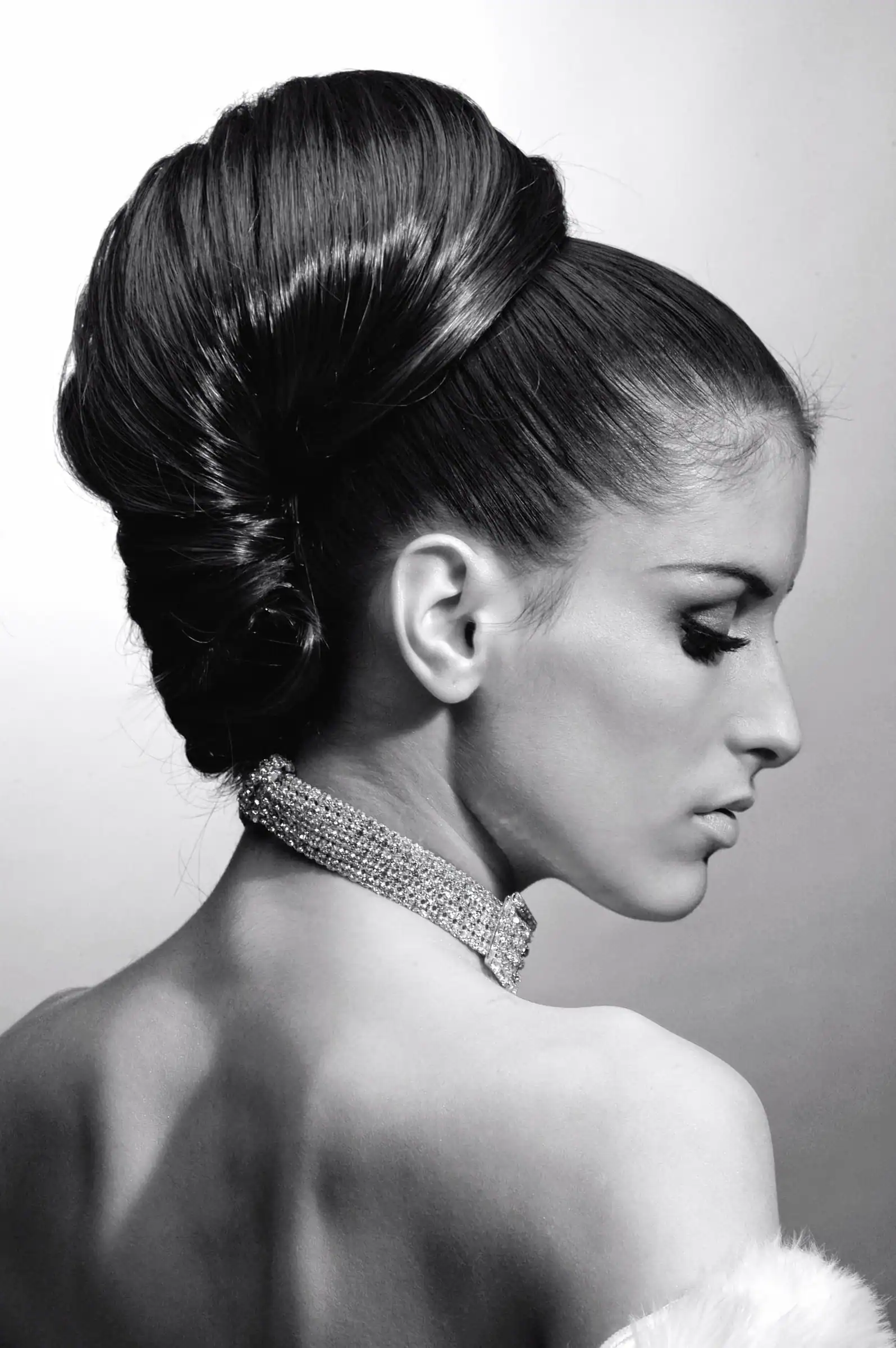 A woman with a tall black and white bouffant chignon