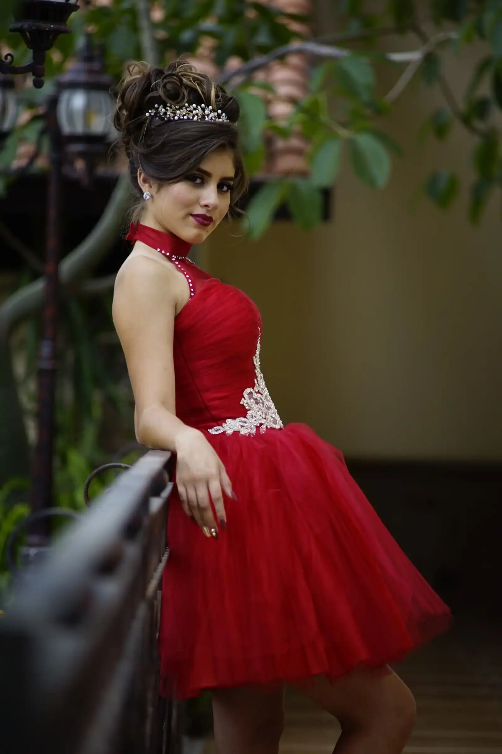 A woman in a red dress with a high updo and a bow